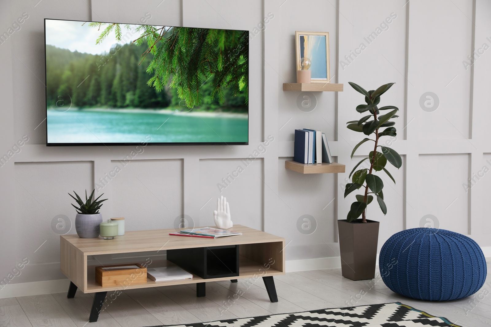 Image of TV set with nature landscape on screen in room