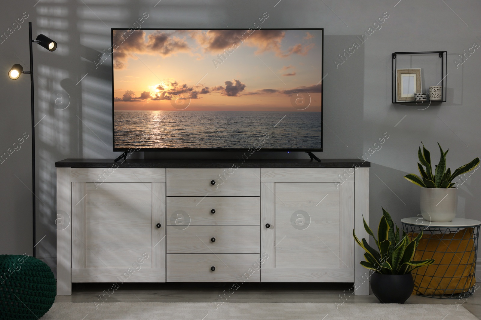 Image of TV set with nature landscape on screen in room