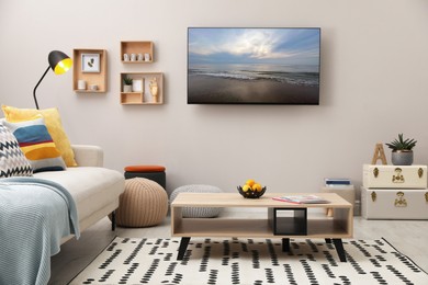 Image of TV set with nature landscape on screen in room