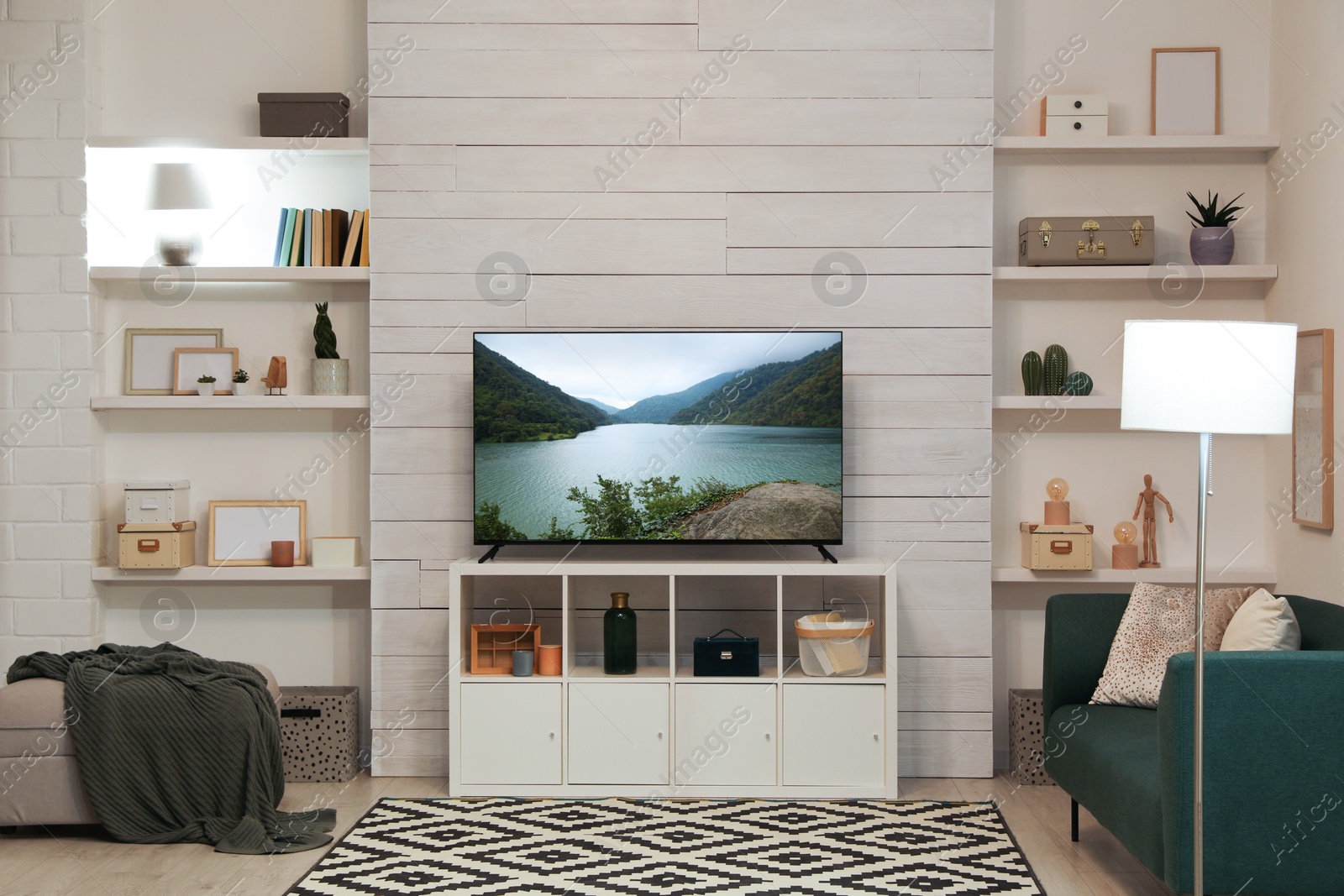 Image of TV set with nature landscape on screen in room