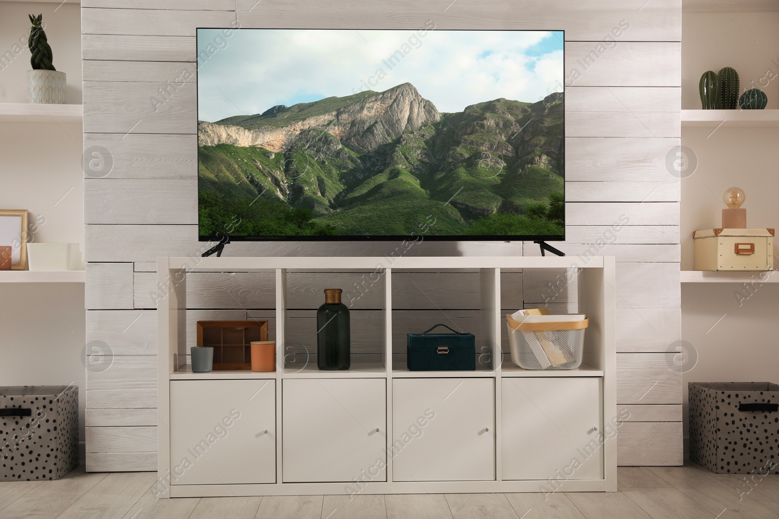 Image of TV set with nature landscape on screen in room