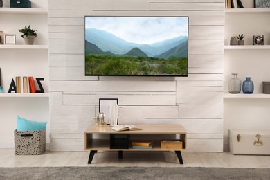 Image of TV set with nature landscape on screen in room