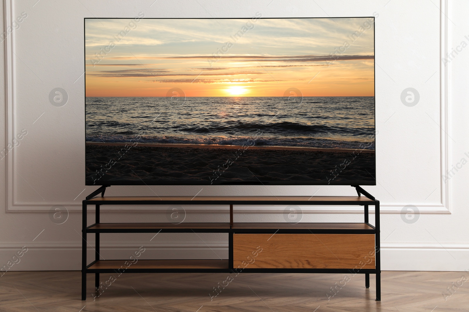 Image of TV set with nature landscape on screen in room