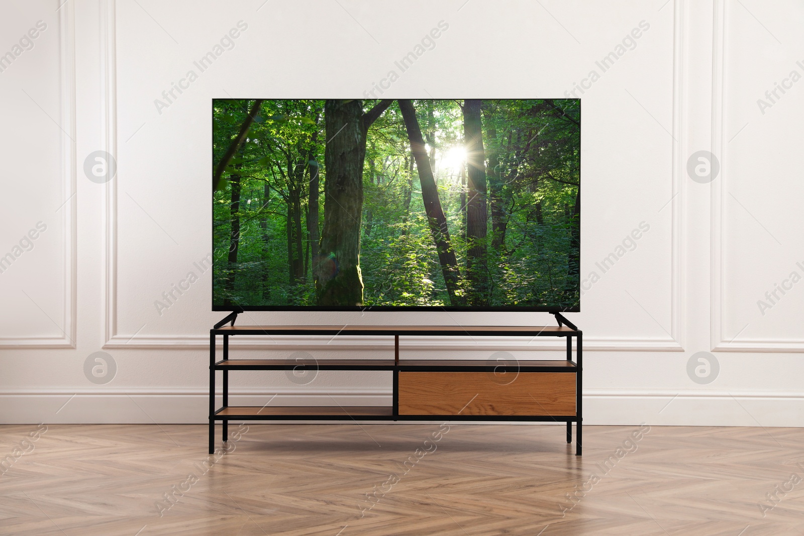 Image of TV set with nature landscape on screen in room