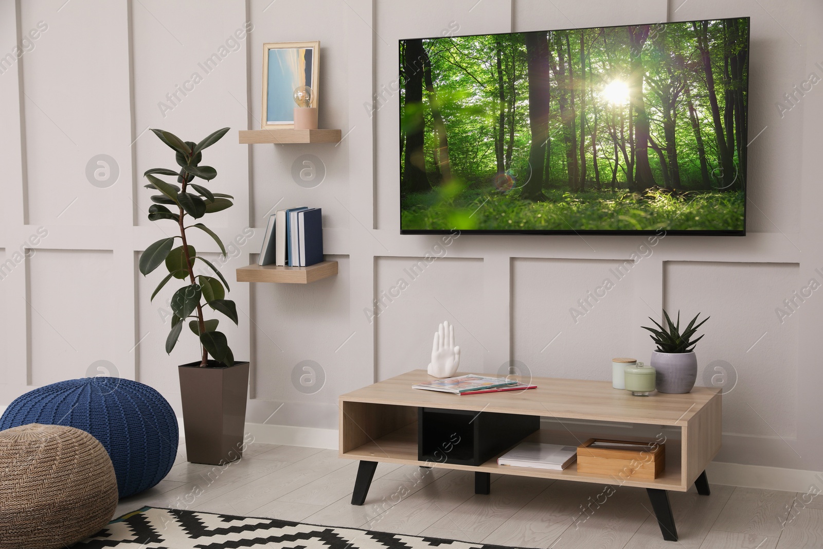 Image of TV set with nature landscape on screen in room