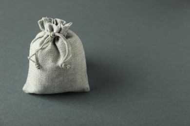 Photo of Burlap sack on gray background. Space for text