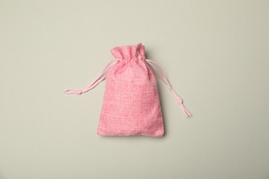 Photo of Pink burlap sack on light gray background, top view