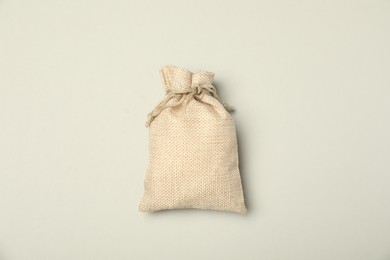 Photo of Beige burlap sack on light gray background, top view