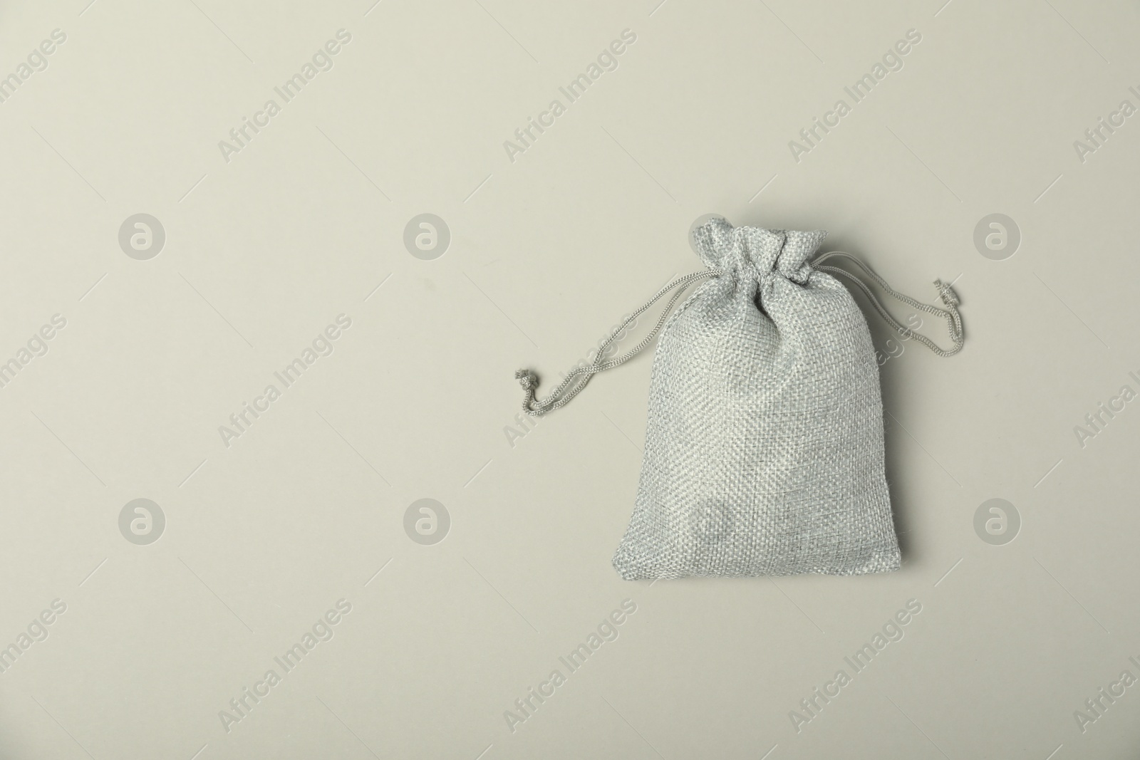 Photo of Burlap sack on light gray background, top view. Space for text