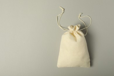 Photo of Beige burlap sack on gray background, top view