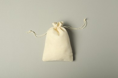 Photo of Beige burlap sack on gray background, top view