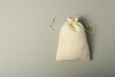 Photo of Beige burlap sack on gray background, top view