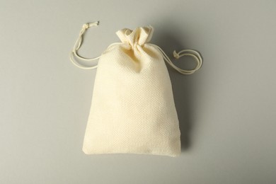 Photo of Beige burlap sack on gray background, top view