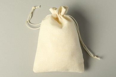 Photo of Beige burlap sack on gray background, top view