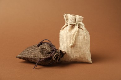 Photo of Two color burlap sacks on brown background