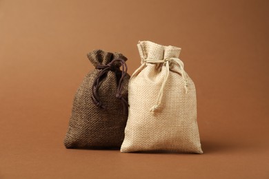 Photo of Two color burlap sacks on brown background