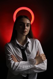 Photo of Beautiful woman with ring lamp on dark red background