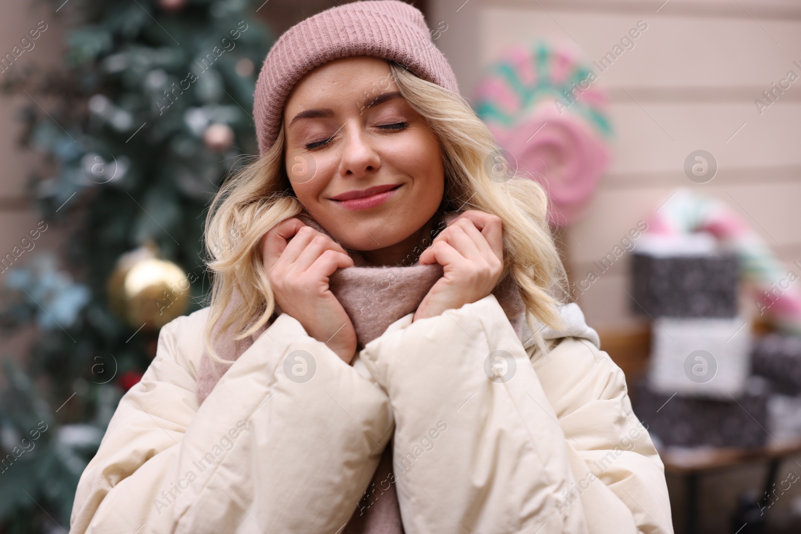 Photo of Portrait of beautiful woman on city street. Christmas season