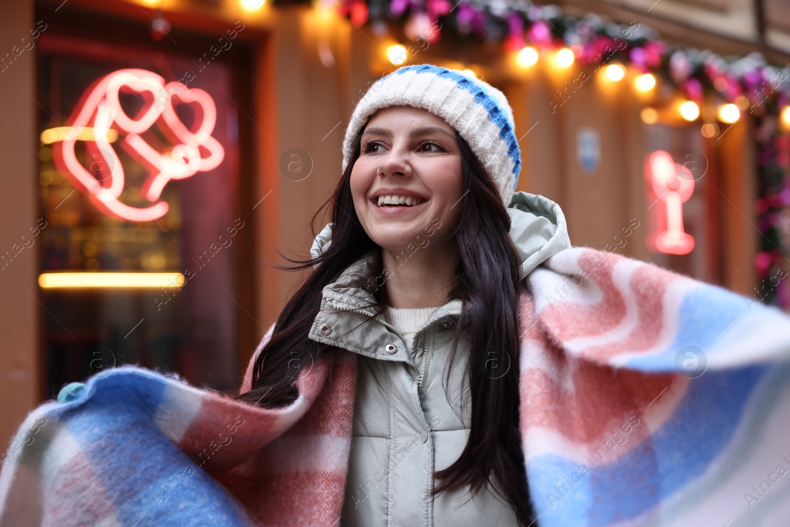 Photo of Portrait of happy woman near shop outdoors. Christmas season