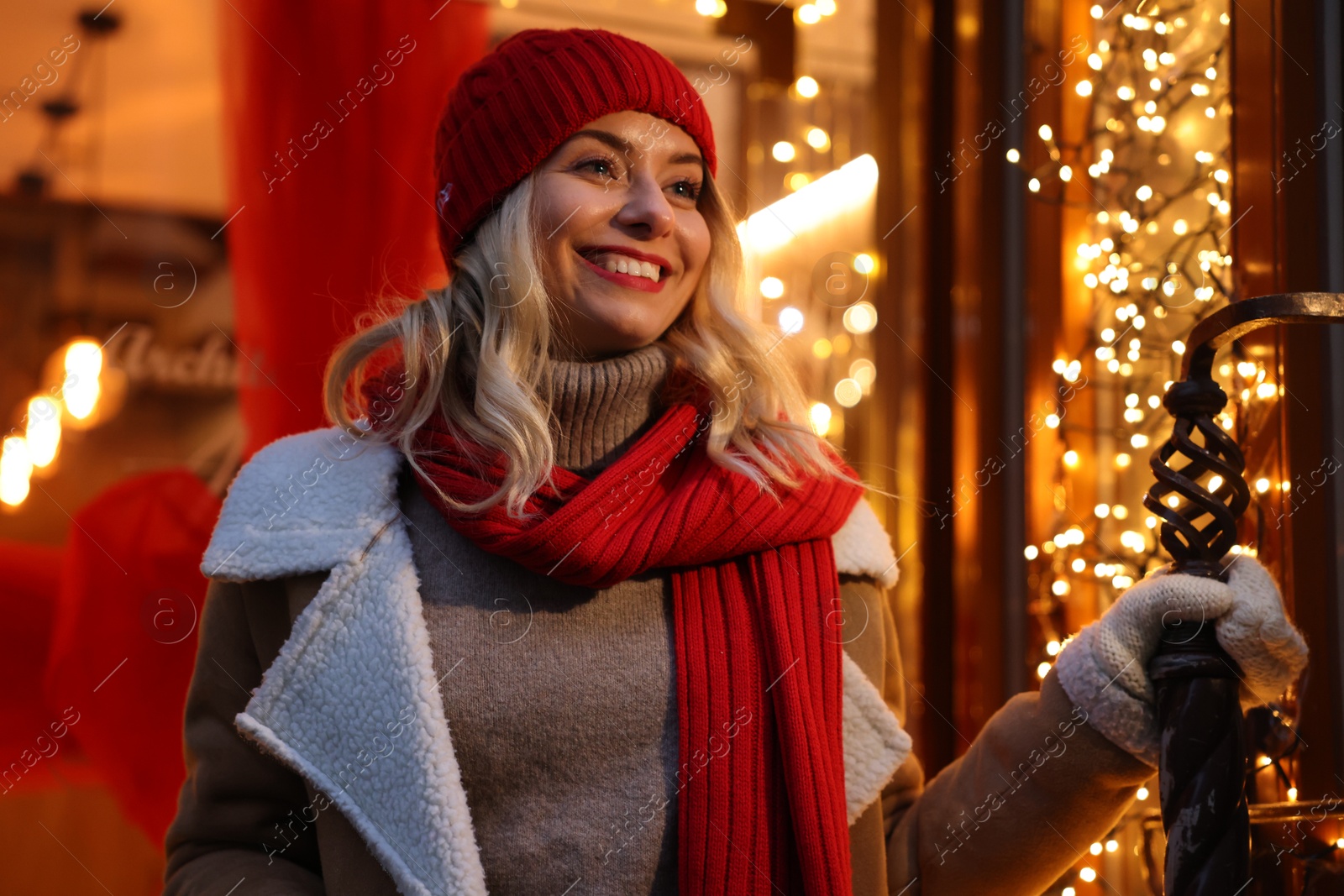 Photo of Portrait of happy woman near shop outdoors. Christmas season