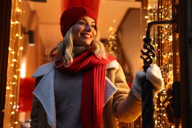 Photo of Portrait of happy woman near shop outdoors. Christmas season