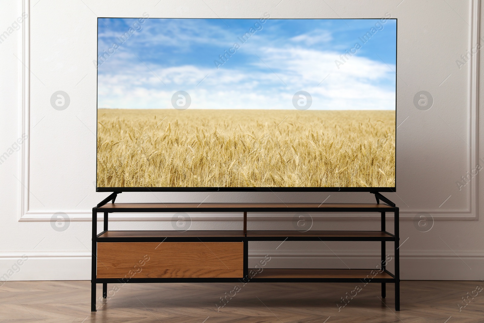 Image of TV set with nature landscape on screen in room