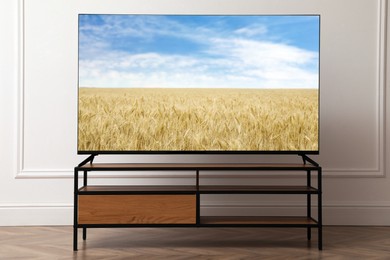 Image of TV set with nature landscape on screen in room