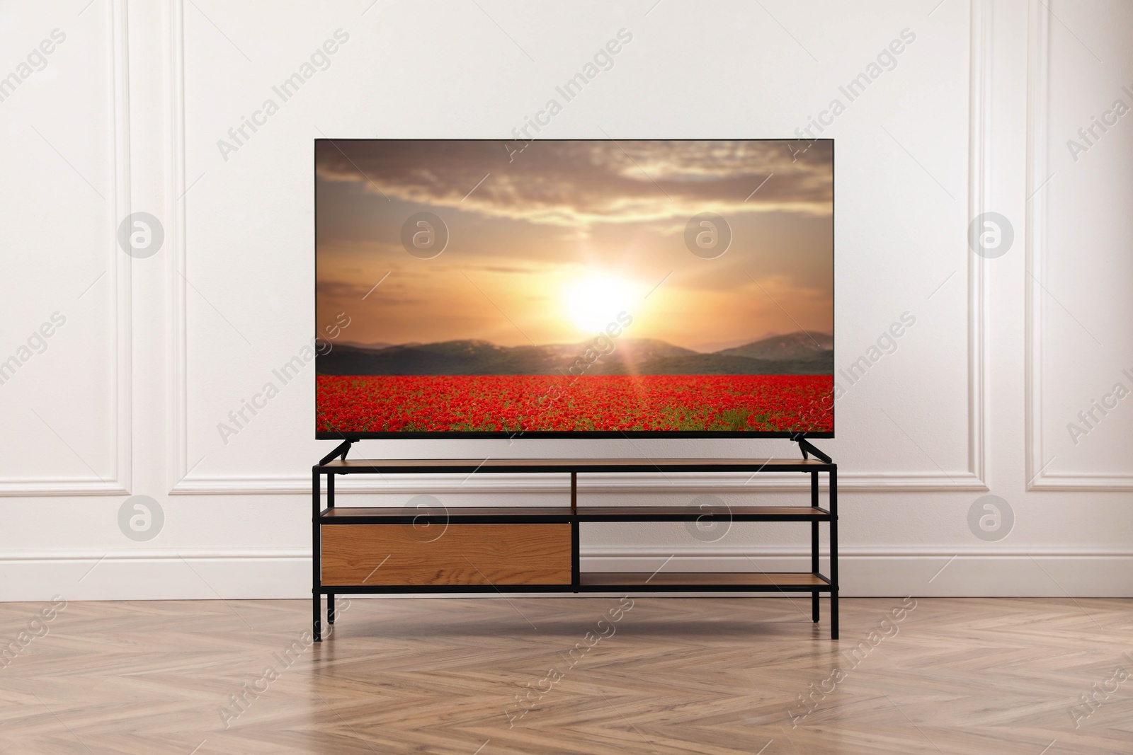 Image of TV set with nature landscape on screen in room