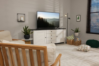 Image of TV set with nature landscape on screen in room