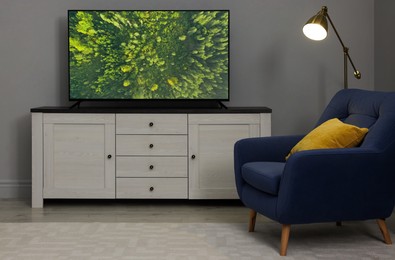 Image of TV set with nature landscape on screen in room