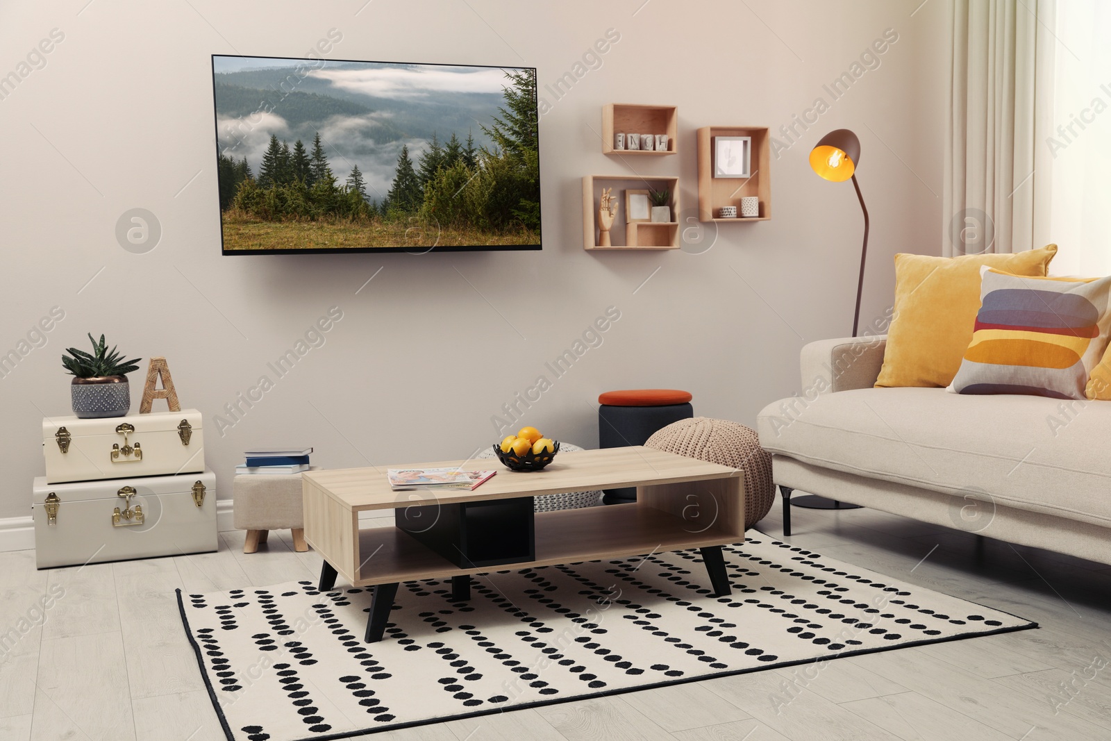 Image of TV set with nature landscape on screen in room