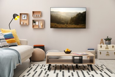 TV set with nature landscape on screen in room