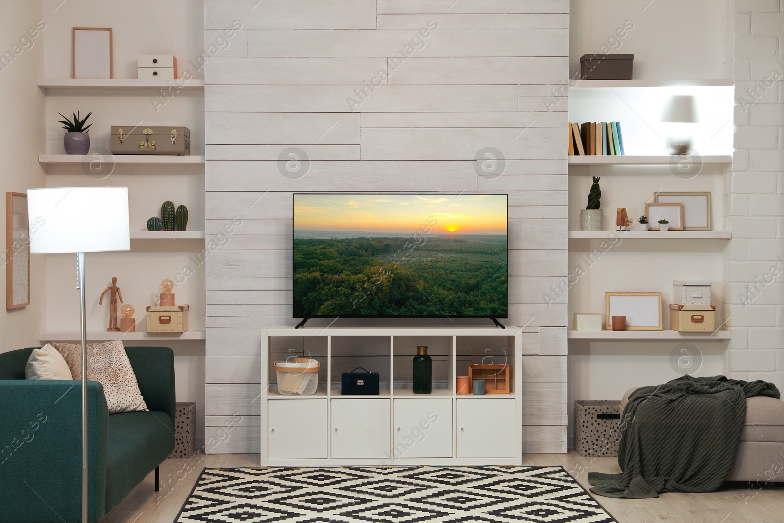 Image of TV set with nature landscape on screen in room