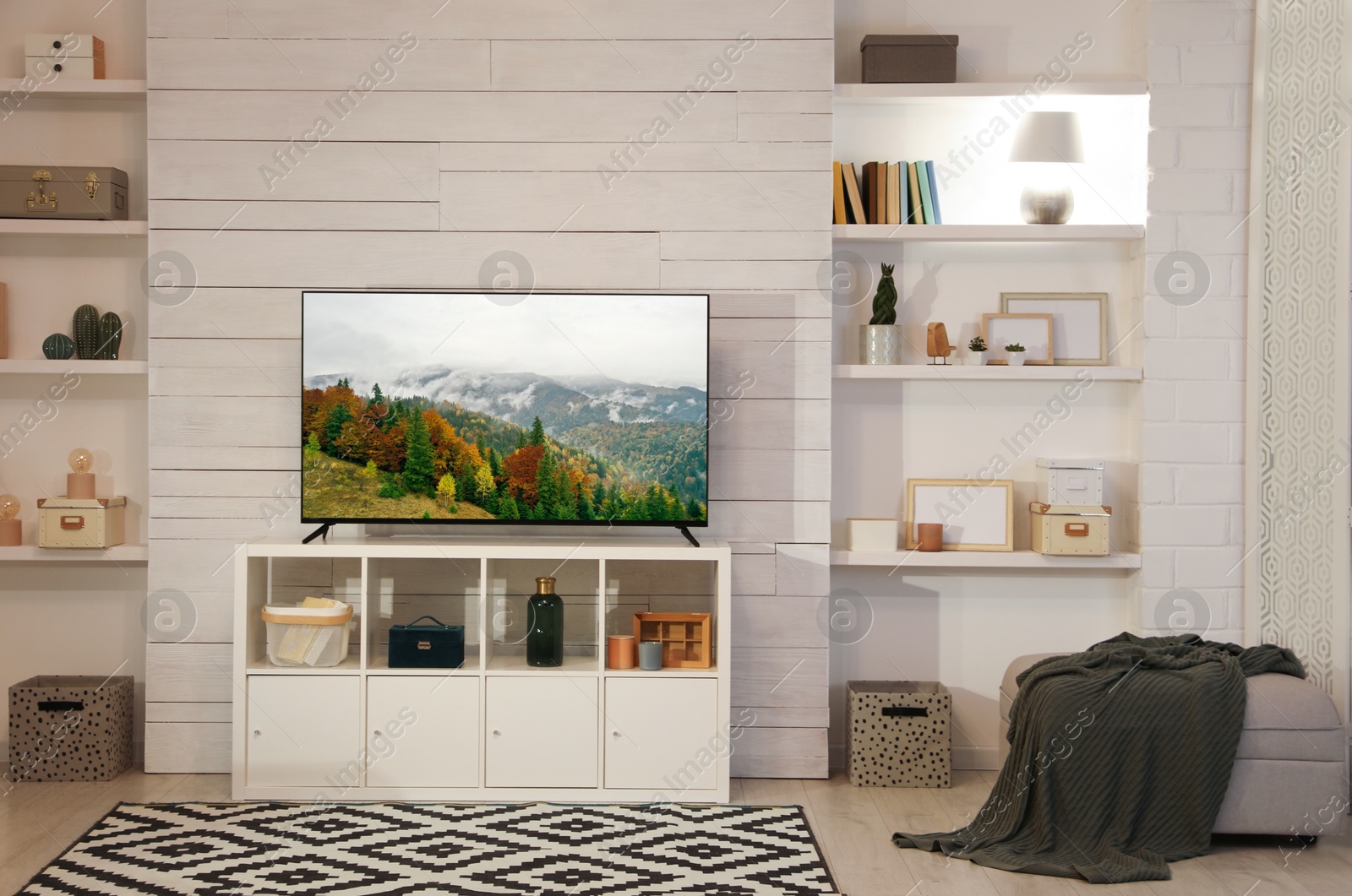 Image of TV set with nature landscape on screen in room