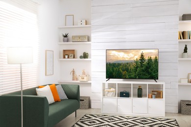 Image of TV set with nature landscape on screen in room