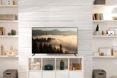 Image of TV set with nature landscape on screen in room