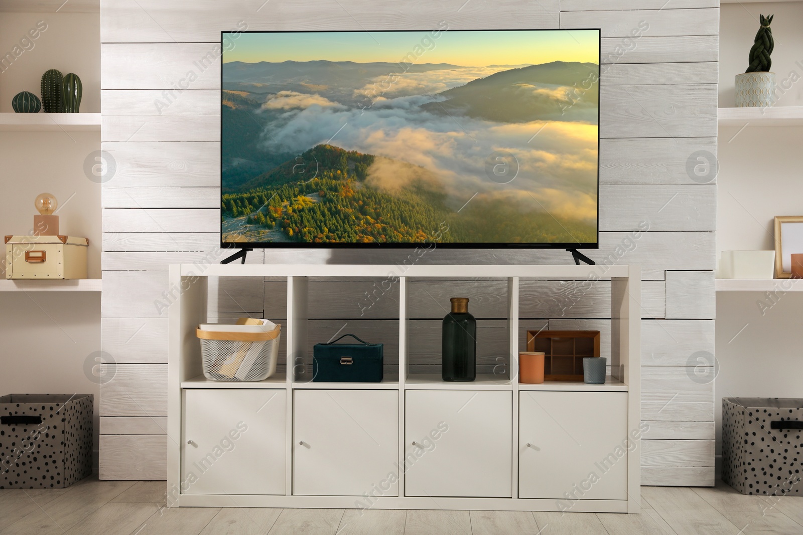 Image of TV set with nature landscape on screen in room