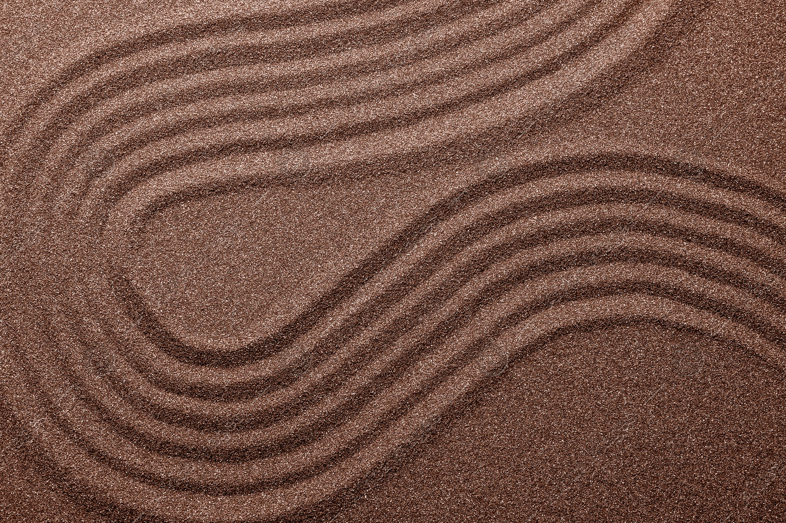 Image of Brown sand with pattern, top view. Mocha mousse - color of 2025 year