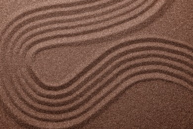 Brown sand with pattern, top view. Mocha mousse - color of 2025 year