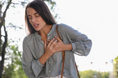 Photo of Young woman having heart attack in park