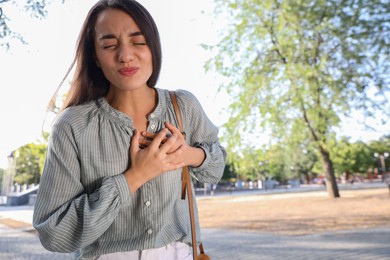 Photo of Young woman having heart attack in park