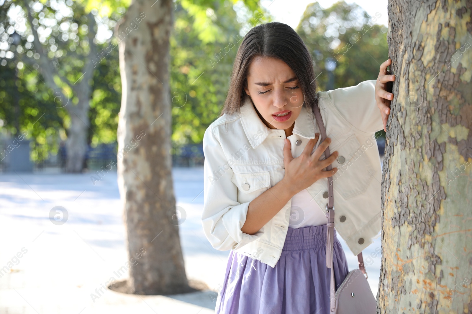 Photo of Young woman having heart attack in park