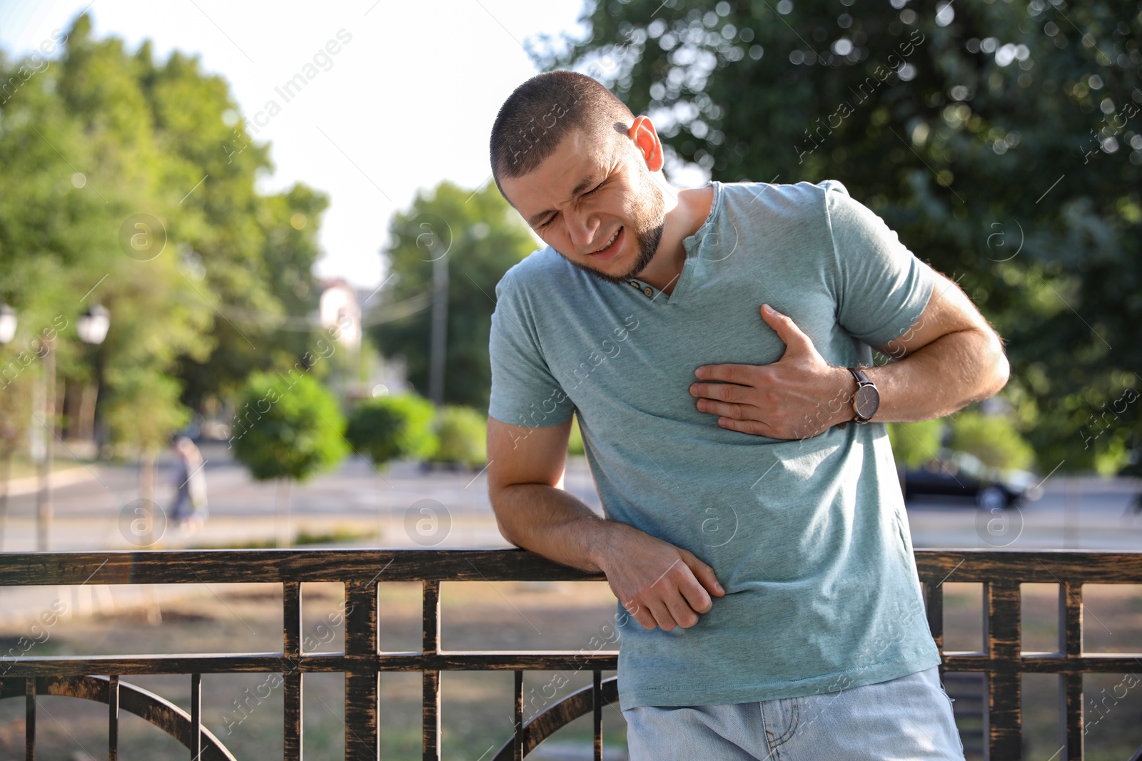 Photo of Man having heart attack on city street