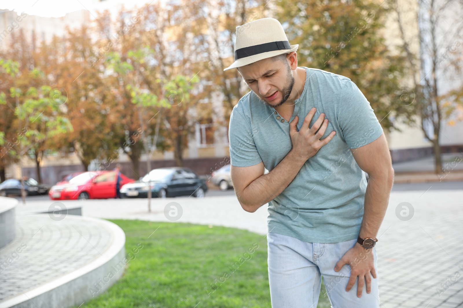 Photo of Man having heart attack on city street