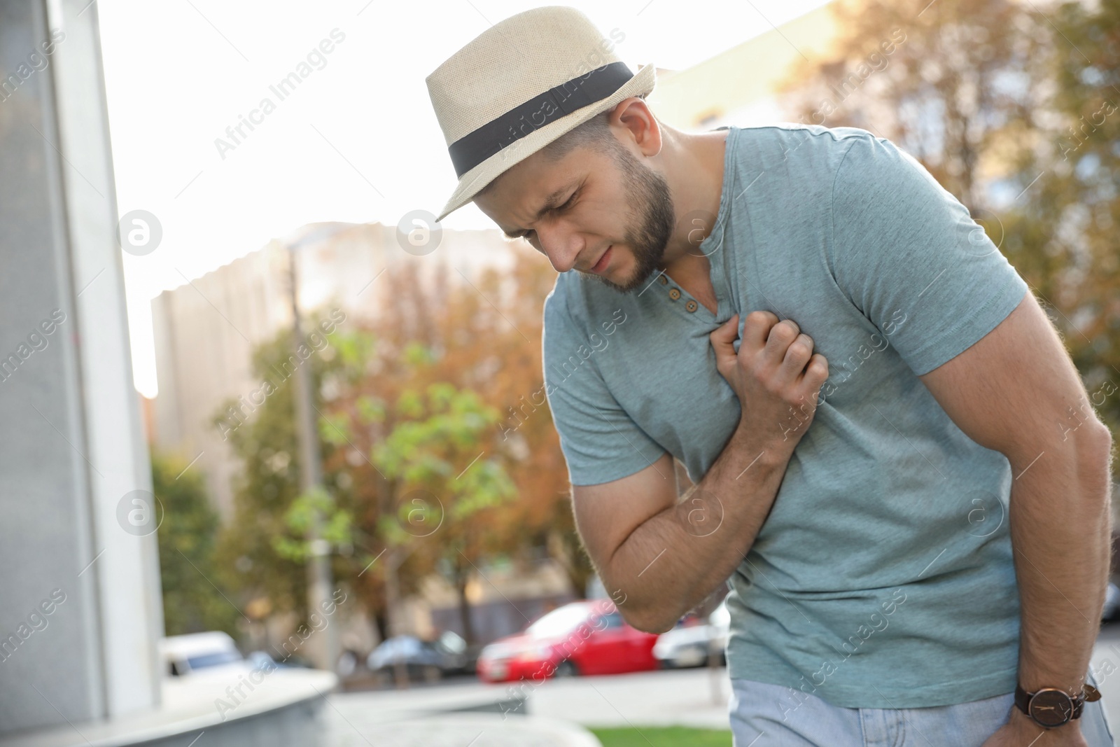 Photo of Man having heart attack on city street