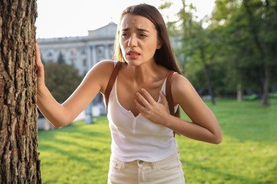 Photo of Young woman having heart attack in park