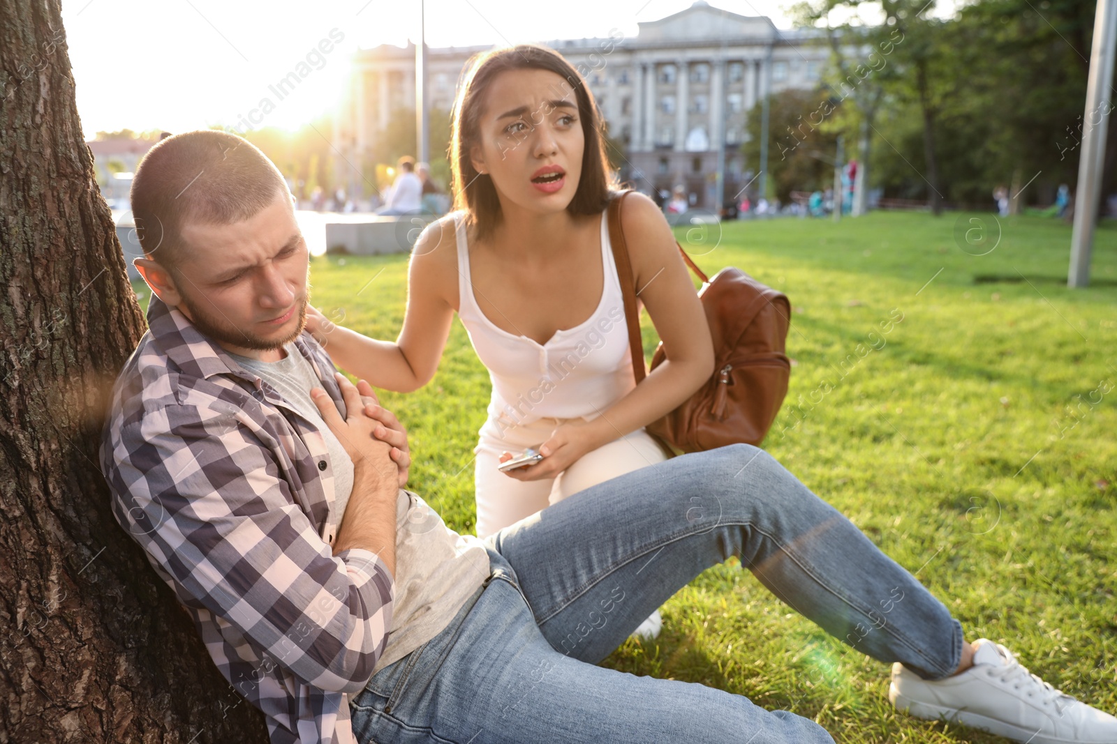 Photo of Woman trying to help man with heart attack in park