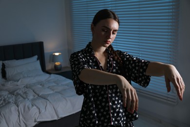 Photo of Young woman suffering from sleepwalking at home