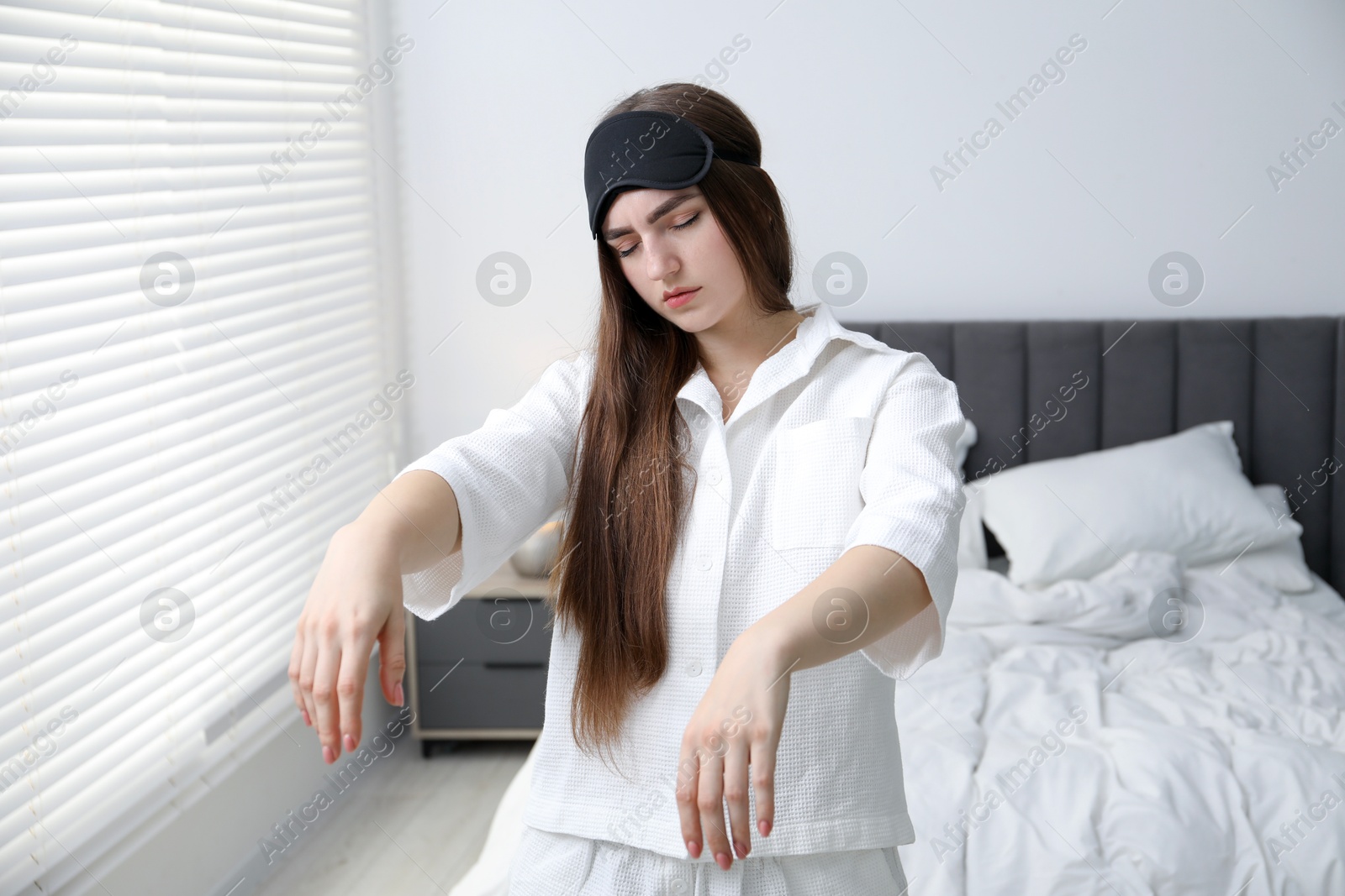 Photo of Young woman suffering from sleepwalking at home