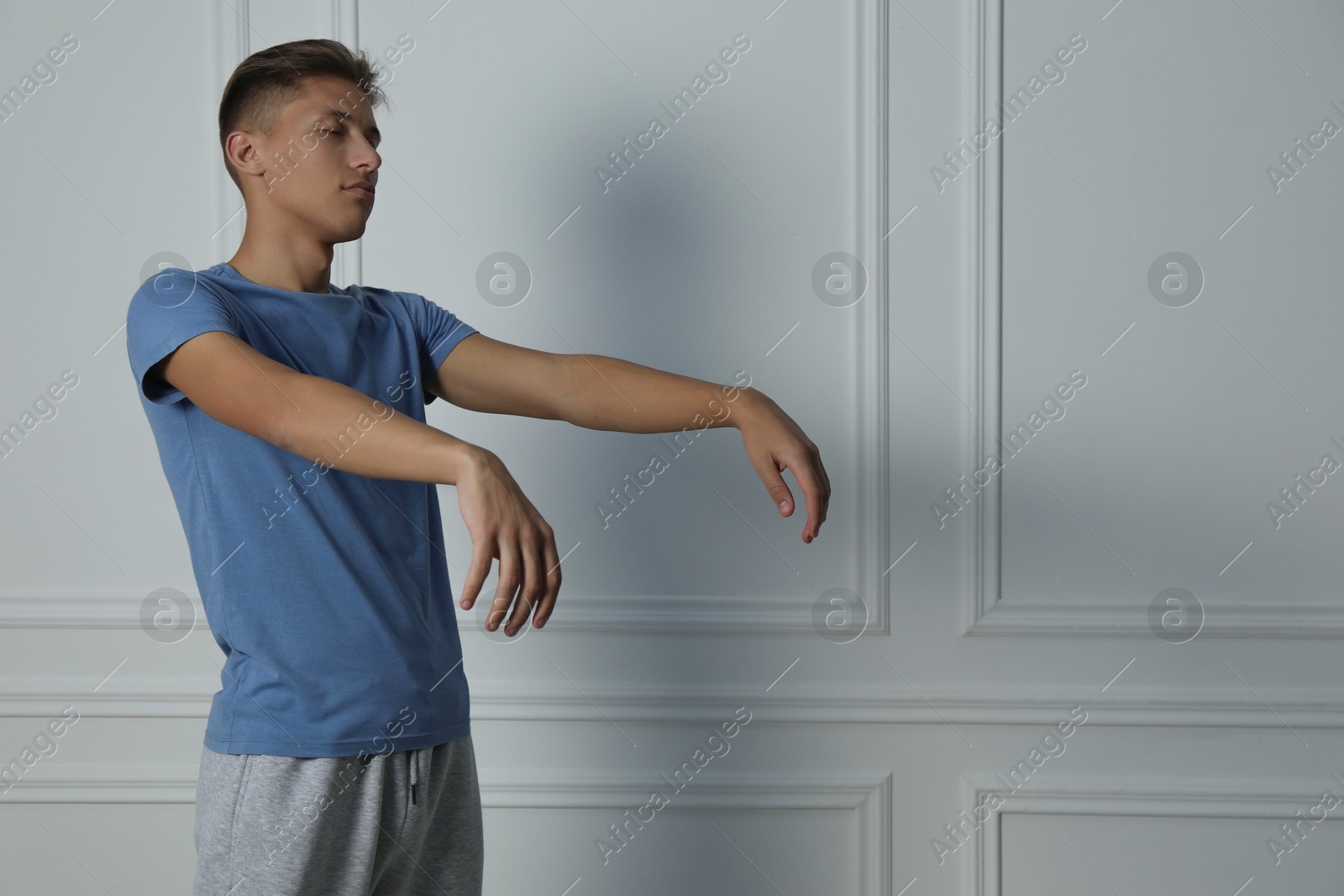 Photo of Young man suffering from sleepwalking at home, space for text